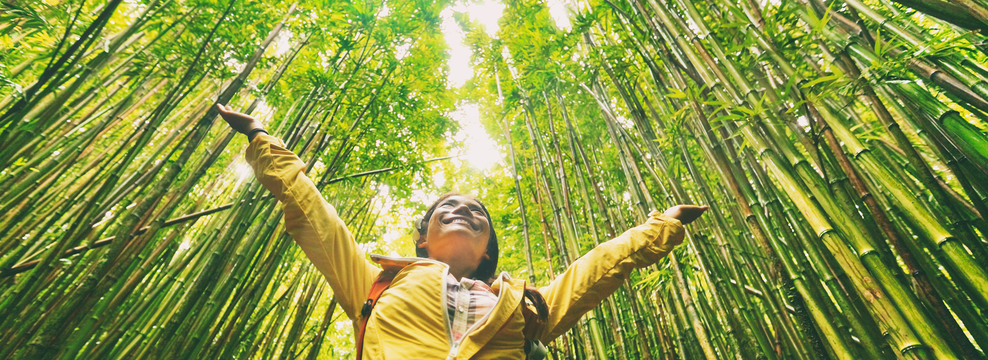 Happy girl in bamboo celebrating sustainability movement.