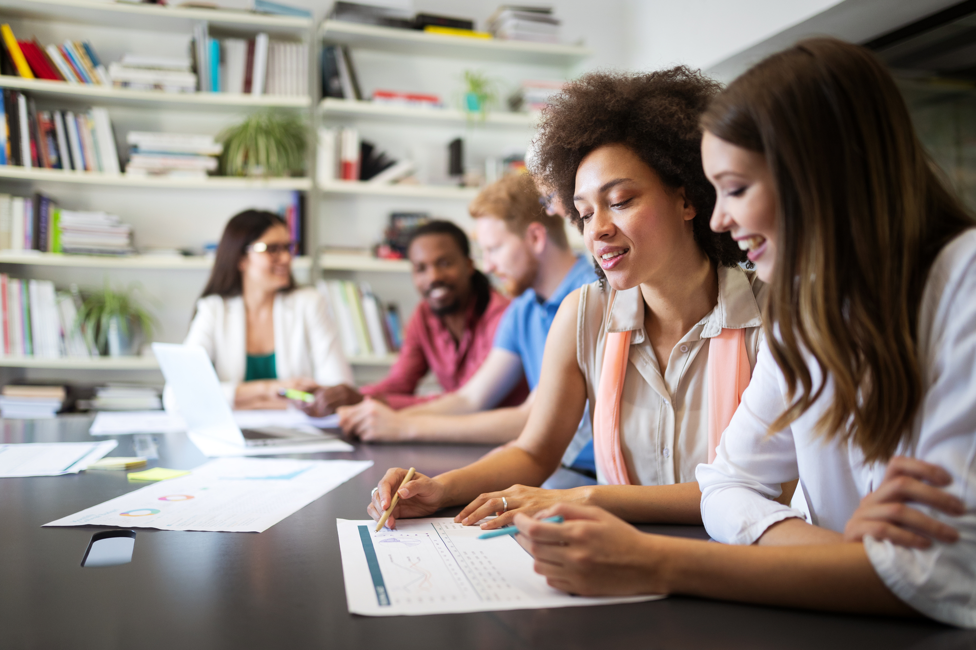 Nonprofit colleagues sit together, collaborating on their organization’s awareness strategy.