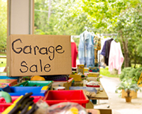 Household items displayed at a community garage sale, raising money for adoption through secondhand treasures.