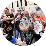 Group of people holding shoes
