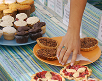 Table filled with delicious baked goods at a community bake sale, raising funds for adoption through homemade treats.