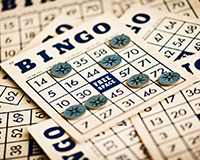 Bingo cards and markers set up for a lively adoption fundraiser event, bringing the community together.