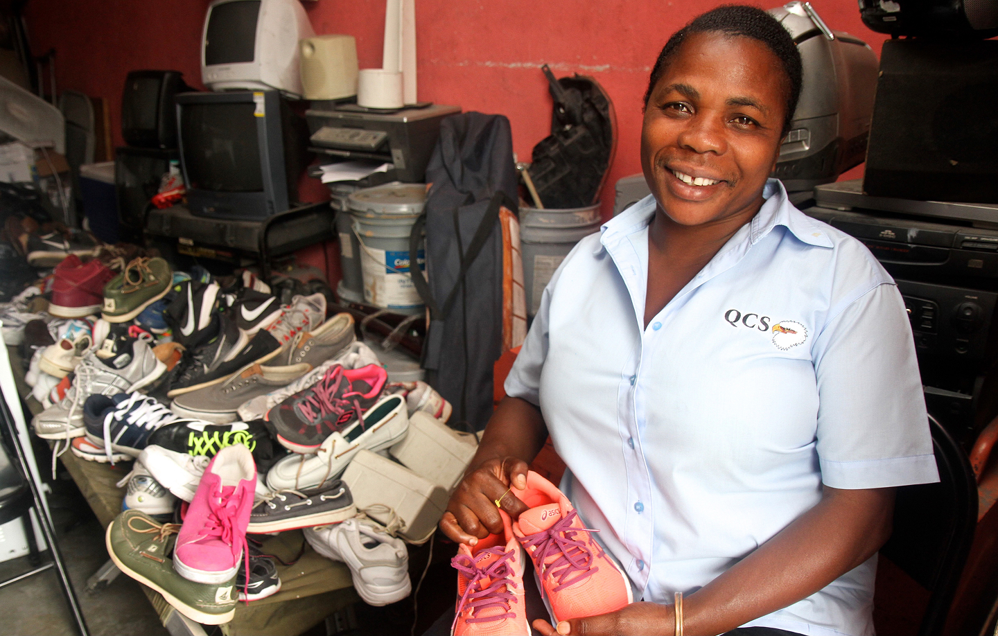 Woman holding small pair of shoes