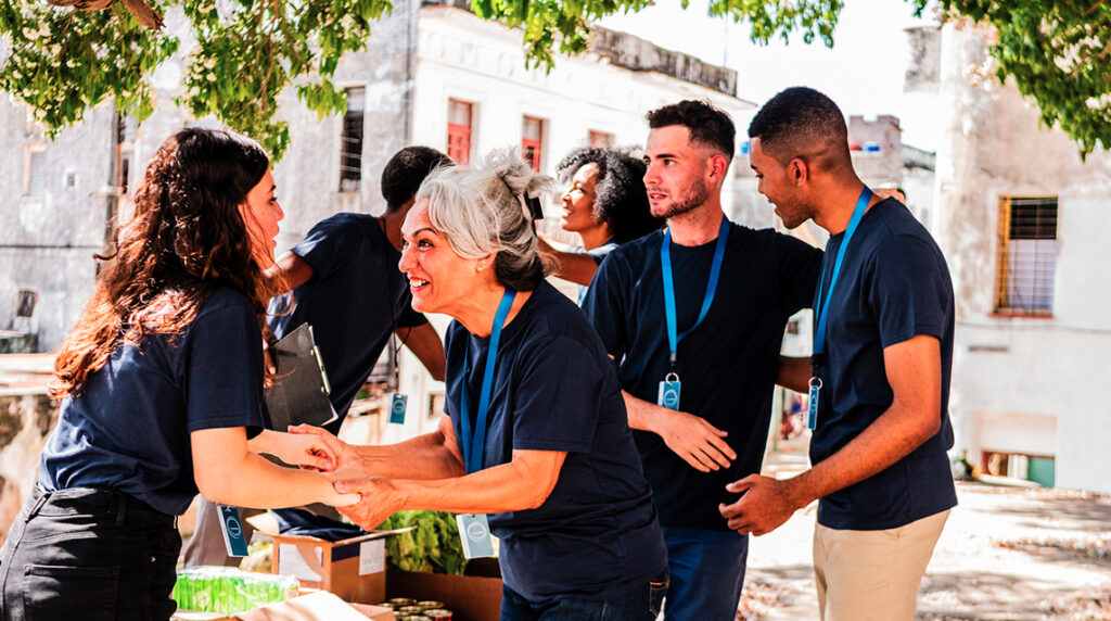 A group of community minded people talking outdoors.