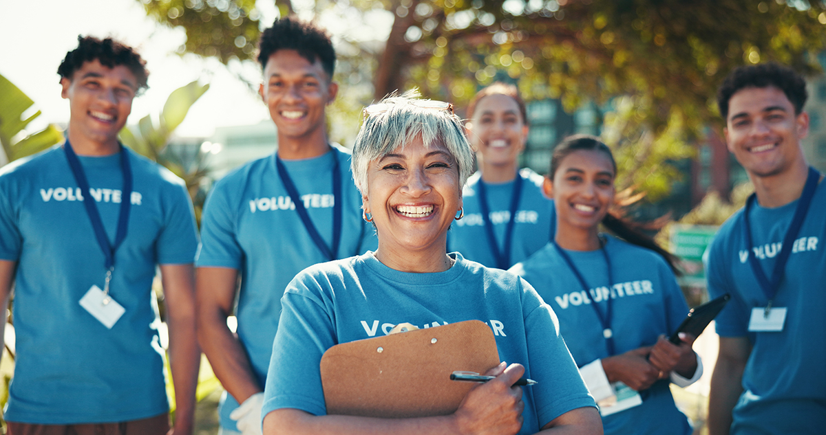 Group of happy volunteers ready to work at a community event.