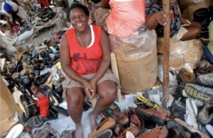 Micro-entreprenuer Silvia posting with the shoes she sells.