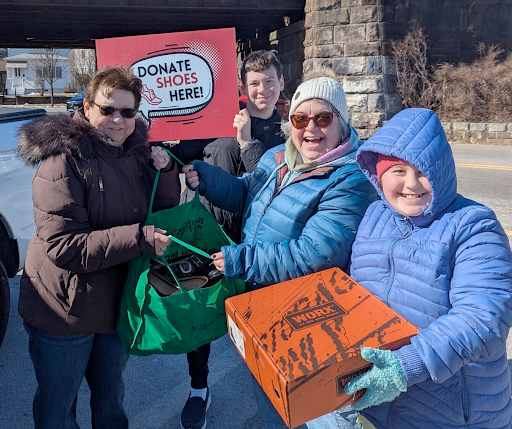 A group of students and parents collect shoes for their school through a PTA shoe drive fundraiser.