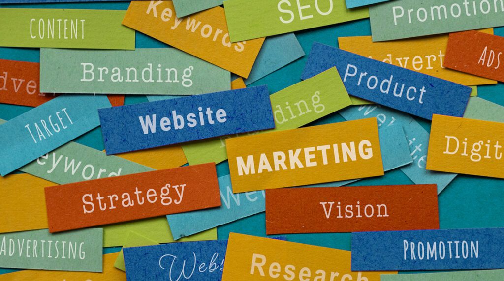 Colorful paper slips displaying keywords, illustrating how to build a fundraiser marketing strategy.
