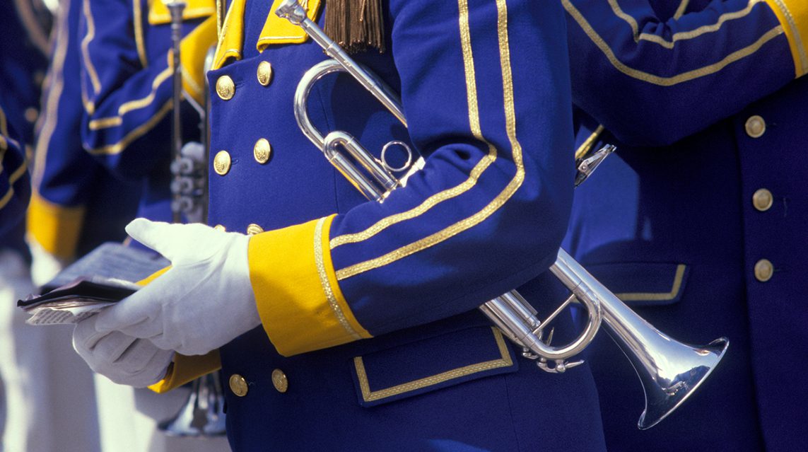 A school marching band wearing marching band uniforms.