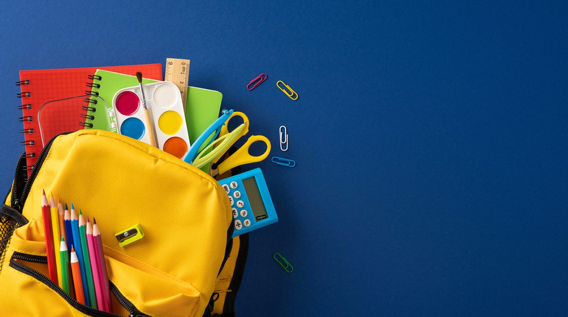 A child’s backpack is full of back-to-school items